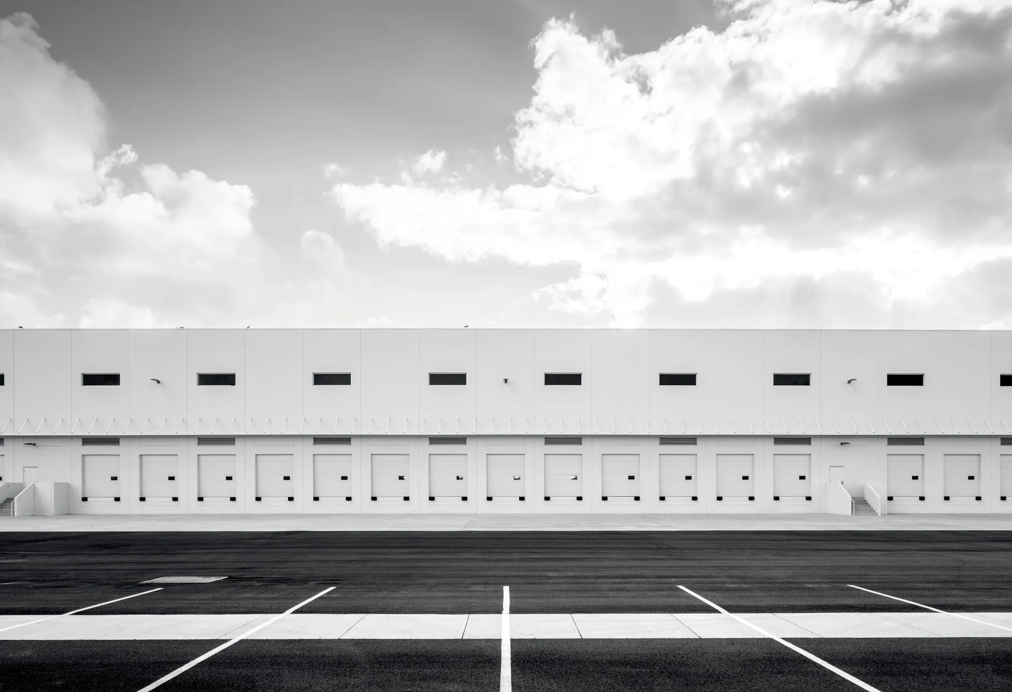 Long row of loading dock doors along a distribution building
